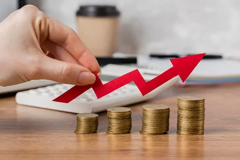 hand holding growth arrow with coins