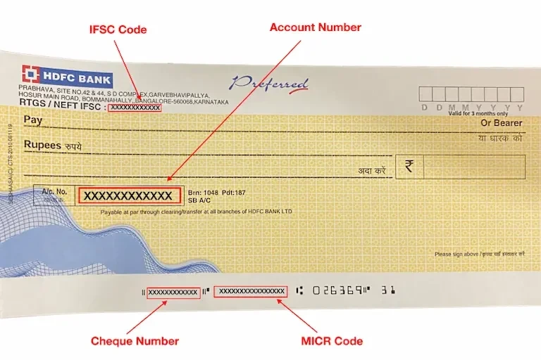 A cheque displaying the account holder's name and address prominently to check IFSC code